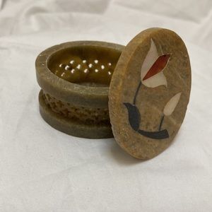 Vintage miniature stone jewelry case with floral design and black jewelry bag.